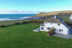 Ariel view of Booby's Bay Cottage with views of the sea and large grassed garden