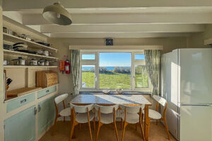 Seating area in well equipped kitchen at Booby's Bay Cottage