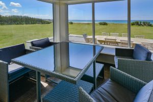 Garden room at Booby's Bay Cottage with views of the sea and large grassed garden