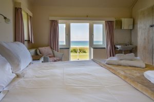 Doors to roof terrace from King sized bedroom at Booby's Bay Cottage