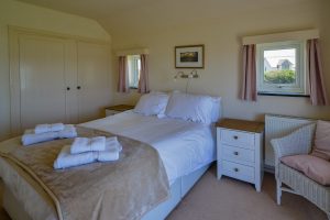 King sized bed at Booby's Bay Cottage