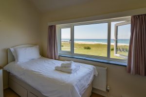 Views of the sea from the window of first floor twin bedroom at Booby's Bay Cottage