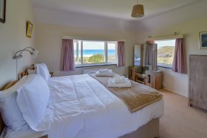 Superking bedroom at Booby's Bay Cottage with sea views, can be a twin bed