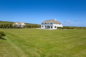 Rear exterior view of Booby's Bay Cottage with large grassed garden