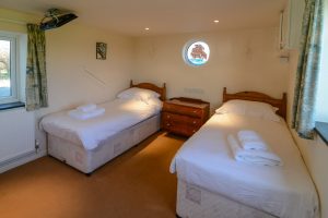 Ground floor twin bedroom which can be a superking also at Booby's Bay Cottage