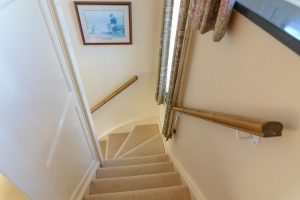 Stairwell leading to the ground floor at Booby's Bay Cottage