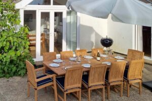 Outdoor table and chairs for eight, with parasol and BBQ at Beachcombers