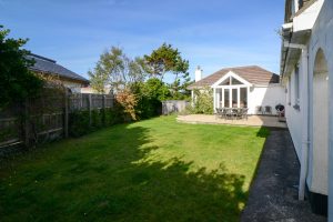 Rear exterior view of Beachcombers with large grassed garden