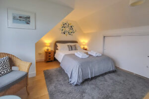 First floor master bedroom with storage and King size bed at Beachcombers