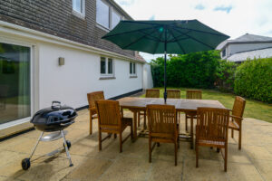 Exterior seating area at Beachcombers with BBQ and parasol