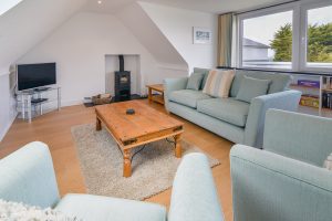 Lounge on first floor at Beachcombers with TV and log burner