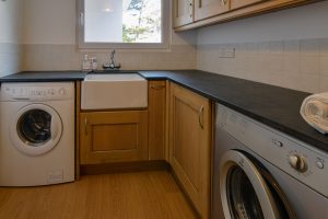 Utility room at Beachcombers with washing machine and drier