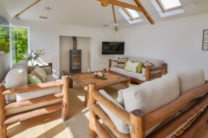 Lounge at Beachcombers with log burner TV and ample seating