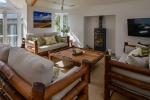 Lounge at Beachcombers with log burner and ample seating