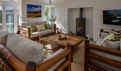 Lounge at Beachcombers with log burner and ample seating