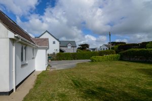 Large grassed front garden and parking area at Beachcombers