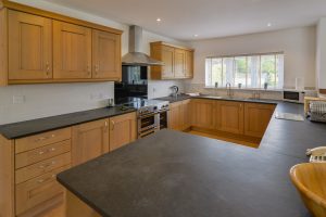Well equipped kitchen at Beachcombers with induction range large oven