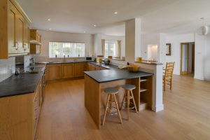 Well equipped kitchen with bar stools at Beachcombers