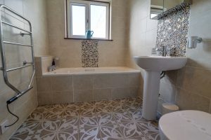 Main bathroom with separate bath and heated towel rail at Bosporthennis