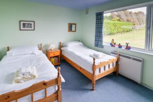 Twin bedroom with views of rear garden from large window