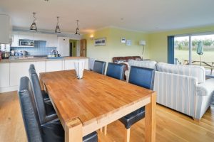 Open plan dining room, lounge and kitchen at Bosporthennis