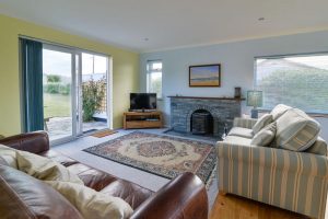 Lounge at Bosporthennis with doors leading to patio