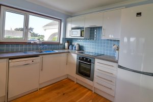 Well equipped kitchen at Bosporthennis with integrated oven and induction hob