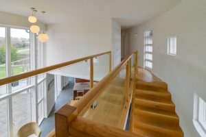 First floor hallway at Cheyney with glass balustrades