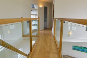 Hall way on first floor at Cheyney with glass balustrade