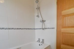Bathroom at Cobs with bath and overhead shower