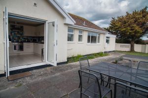 Exterior rear view of Cobs with patio and dining area