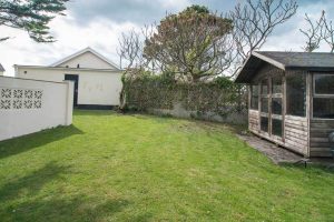 Grassed garden to the rear of Cobs with summer house