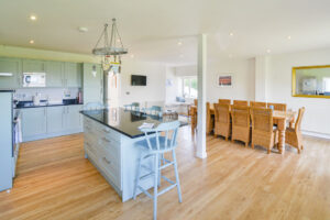 Open plan kitchen and dining area with ample seating at Curlews