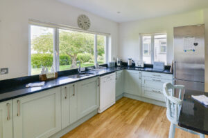 Well equipped kitchen at Curlews with views to rear garden