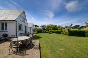 Grassed garden to the rear of curlews with patio and seating