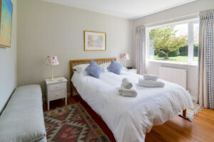 King sized bedroom with garden views at Curlews