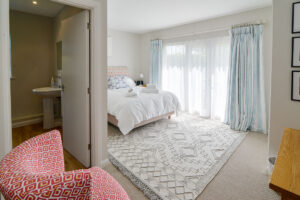 Ground floor king bedroom with patio doors and ensuite