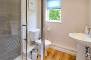 Ensuite from master bedroom on ground floor with walk in shower at Curlews