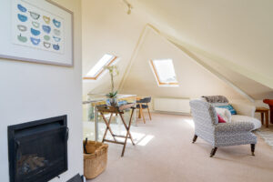 First floor lounge area with log burner at Curlews
