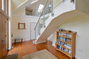 Front entrance hallway at Curlews with staircase leading to first floor