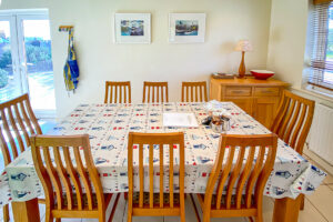 Dining area at Cobs with patio doors leading to the back garden