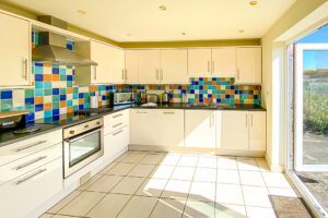 Well equipped kitchen at Cobs with double doors leading to the rear garden