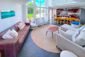 Open plan lounge and kitchen at Cheyney with ample seating