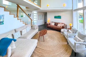 Lounge area with ample seating and staircase leading to first floor at Cheyney