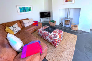 Lounge with log burner and TV at Cheyney