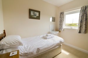 One of two single bedrooms at South Corner with wash hand basin