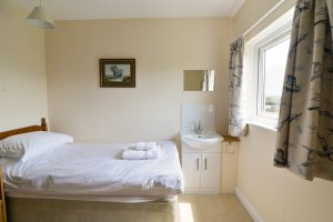 One of two single bedrooms at South Corner with wash hand basin