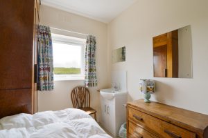 One of two single bedrooms at South Corner with wash hand basin