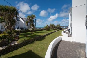 Grassed communal garden area with sea views at Apartment 5 Greenwaves