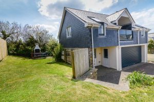 Exterior view with grassed garden area and BBQ at Aquataine Annexe